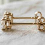 Gold diamond post earrings showing the straight post and butterfly back